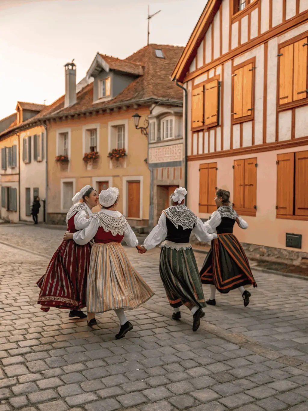 A lively image of a traditional Breton dance performance, with dancers in traditional attire performing intricate steps.